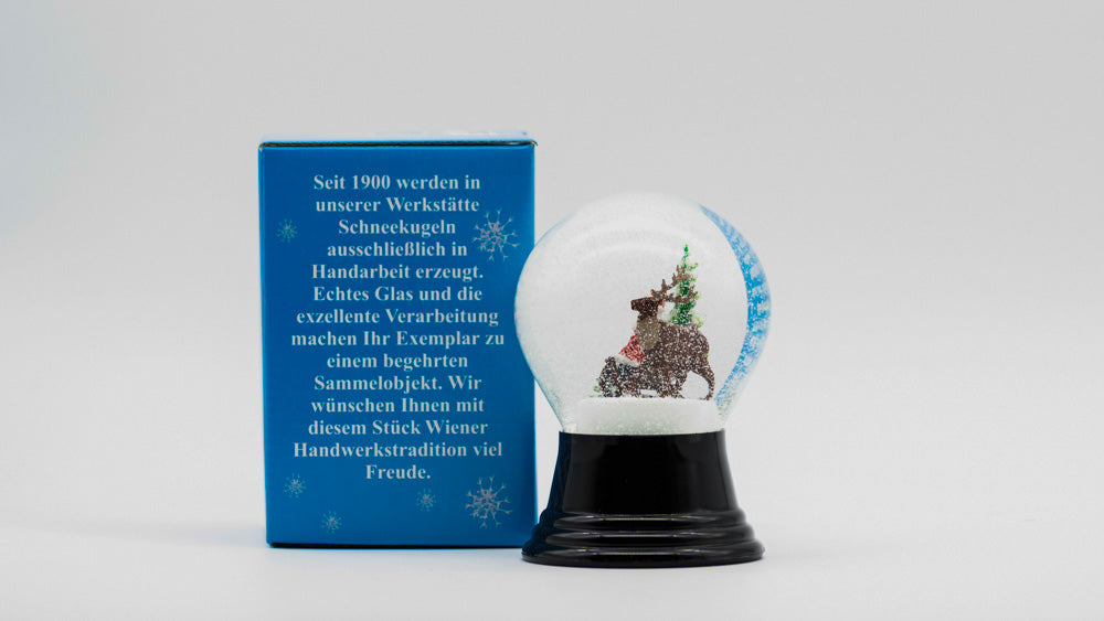 schneekugel mit weihnachtsmann und Renntier mit Verpackung