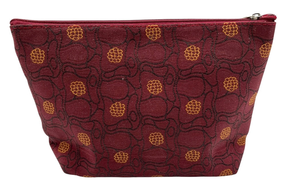 Kosmetiktasche im Design „Sommerwind“ von Josef Hoffmann. Der Stoff in Rotmit goldenen Blüten und schwarzen linien - ansicht seitlich von oben