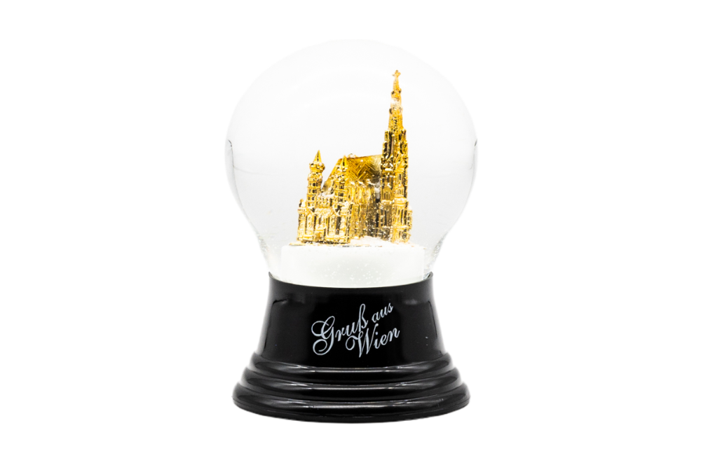 schneekugel mit glóldenen stefansdom und schriftzug Gruß aus wien
